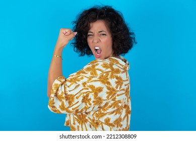 Profile Side View Portrait Brunette Arab Woman Wearing Hawaiian Shirt Over Blue Background Celebrates Victory