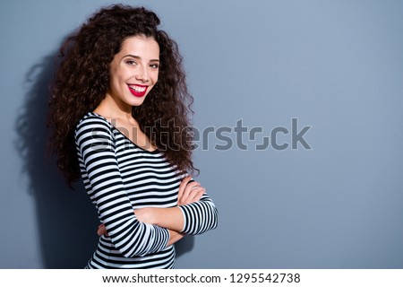 Profile side view portrait of her she nice-looking cute charming attractive lovely cheerful cheery wavy-haired lady in striped pullover isolated over gray pastel background