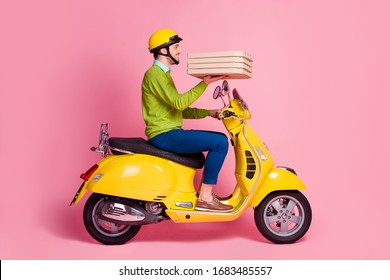 Profile side view portrait of his he nice attractive confident glad cheerful cheery guy driving moped bringing dessert baked pie call house isolated over pink pastel color background