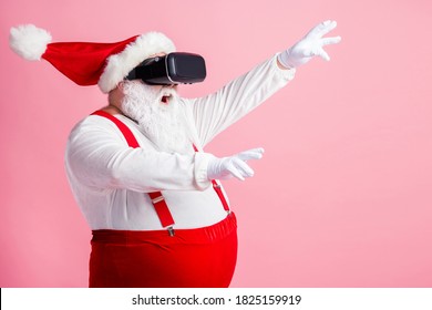 Profile side view portrait of his he bearded fat overweight Santa wear vr helmet gadget device equipment enjoying watching realistic experience air blow wind isolated pink pastel color background - Powered by Shutterstock