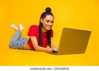 Profile Side View Portrait Of Lovely Cheery Girl Lying Using Laptop Typing Blogging Isolated On Bright Yellow Color Background