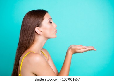 Profile side view portrait of nice positive attractive cute sweet tender straight-haired girl, sending air kiss, isolated on green turquoise background