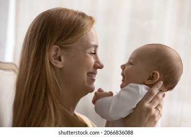 Profile Side View Smiling Loving Young Mother Playing With Baby Close Up, Happy Caucasian Mom And Little Newborn Child Enjoying Tender Moment, Looking In Eyes, Family And Motherhood Concept