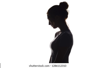 profile silhouette of a pensive girl, a young sad woman lowered her head down on a white isolated background