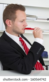 Profile Of Stressed Business Man Chewing Pen