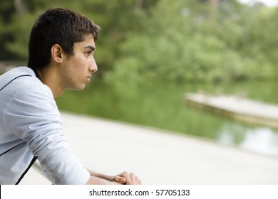 Profile of a Teenage Indian Boy Looking at Water in a Park