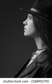 Profile Of Teenage Model In Fedora Hat Posing In Studio, Monochrome Photo