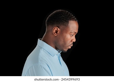 Profile of a thoughtful man on a dark background - Powered by Shutterstock