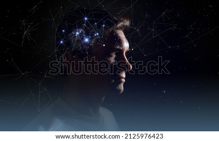The profile of a thoughtful young man, the concept of brain activity of self-knowledge and personality development. Thinking like stars, the cosmos inside human, background night sky