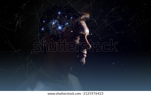 The profile\
of a thoughtful young man, the concept of brain activity of\
self-knowledge and personality development. Thinking like stars,\
the cosmos inside human, background night\
sky