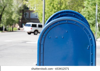 Profile of two blue mail boxes on the street