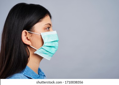 Profile View Of Asian Woman In Protective Mask