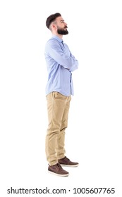 Profile View Of Bearded Young Adult Business Man With Crossed Arms Looking Up. Full Body Length Portrait Isolated On White Studio Background.