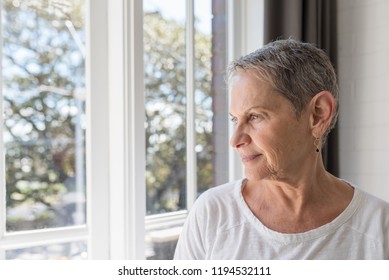 Profile View Of Beautiful Older Woman With Short Grey Hair Next To Window (selective Focus)