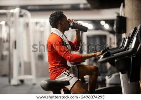 Similar – Image, Stock Photo Young athlete refreshes himself with water after a hard workout on the athletic oval in the intense heat. Endurance training. Brown-haired adolescent