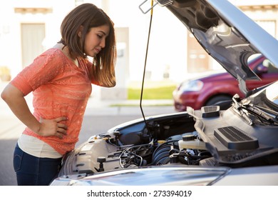 Profile View Of A Cute Young Frustrated Woman Looking At His Car Hood Open