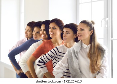 Profile View Of Group Of Happy Confident Young Women In Their 20s And 30s Standing In Row Hand On Hip, Looking Away. Concept Of Female Team, Unity, Support, Success And Positive Outlook For Future