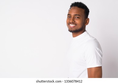 Profile view of happy young handsome African man looking at camera - Shutterstock ID 1336078412