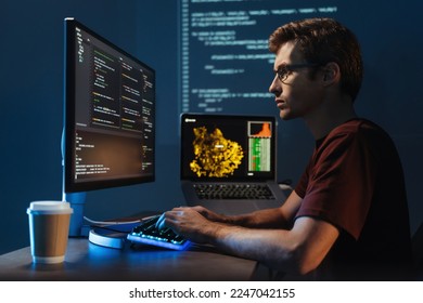 Profile view portrait of young guy data scientist working at pc at home late night, debugging script cyber space error, isolated on wall with zoomed digital page - Powered by Shutterstock