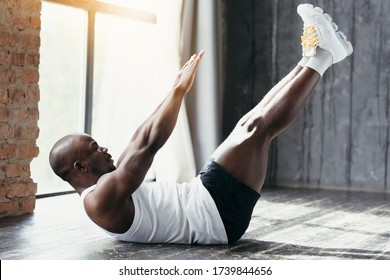 Profile View Of A Sporty African American In A White T-shirt Doing An Exercise On The Muscles Of The Upper Abs And Lower Abdomen