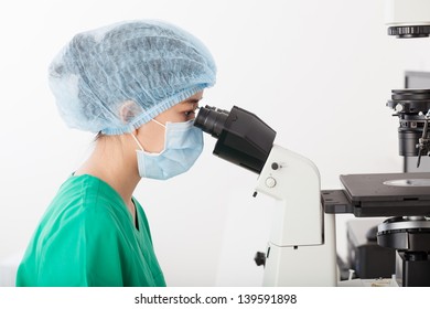 Profile View Of A Woman Looking Through The Electronic Microscope