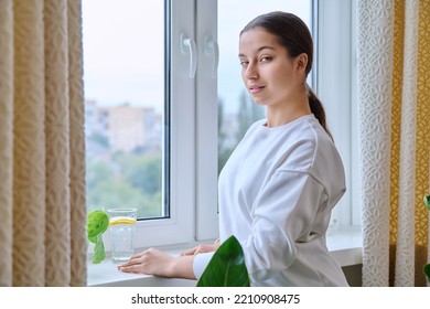 Profile View Of Young Calm Female Looking Out The Window In Distance