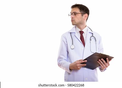 Profile View Of Young Man Doctor Holding Clipboard While Looking Away