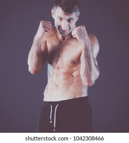 Profile view of young man practicing boxing .Personal instructor. Personal training.