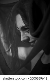 Profile Of A Woman In A Black Veil. Costume Dead Bride For Halloween. Portrait Of An Evil Grinning Witch In Front Of A Coven.