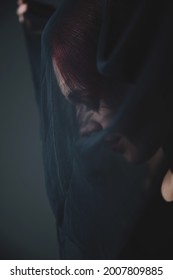 Profile Of A Woman In A Black Veil. Costume Dead Bride For Halloween. Portrait Of An Evil Grinning Witch In Front Of A Coven.