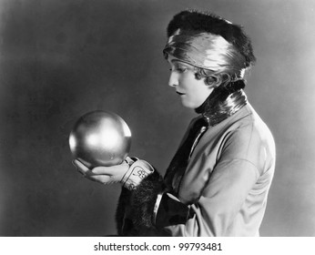 Profile of a woman holding a metal ball