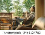 Profile of a woman in a house terrace drinking coffee and breathing