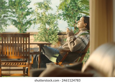 Profile of a woman in a house terrace drinking coffee and breathing - Powered by Shutterstock