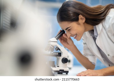 Profile Of Woman Looking Through Microscope