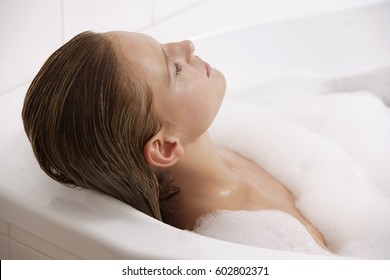 Profile Of Woman Reclining In Bath Tub