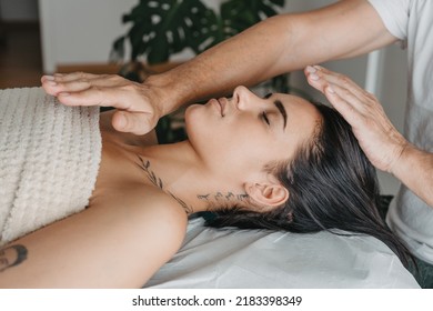 Profile of a woman while receiving energy in a Reiki therapy - Powered by Shutterstock