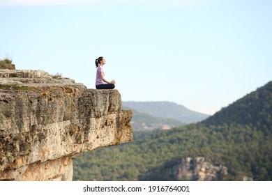 Profile Of A Yogi Practicing Yoga Exercise Alone In The Top Of A Mountain