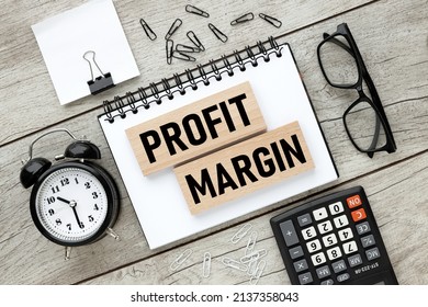 Profit Margin text on wooden blocks on an open notepad - Shutterstock ID 2137358043