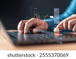 profit, report, strategy, financial, trade, growth, trader, chart, graph, invest. A person is using a laptop with displaying a graph of stock prices. possibly making a trade or inputting data.