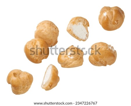 Profiteroles and halves fly close-up on a white background. Isolated