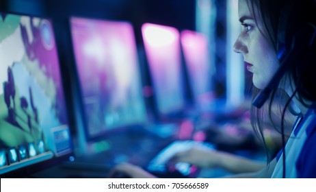 Progamer Girl Playing In MMORPG/ Strategy Video Game And Participating In Online Cyber Games Tournament Or Playing In Internet Cafe.