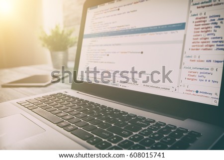 Program code web page displayed on a laptop screen.