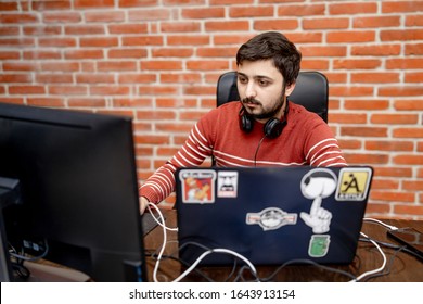 Program development concept. Young man working with computer