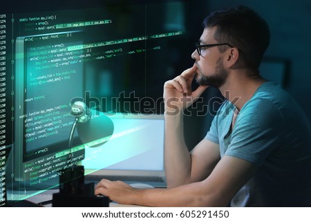 Program development concept. Young man working with computer