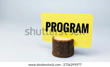Program Planning Concept Displayed on Yellow Sign Placed on Wooden Holder Representing Schedule Management, Organization, and Business Coordination. 