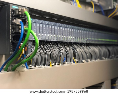 Programmable Logic Controller PLC comprised of analog and digital input and output with power supply and processor module this being used water treatment system control, selective focus.