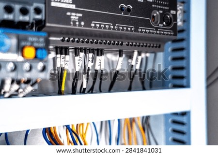 Programmable logic controller (plc) with connected wires in an industrial control panel