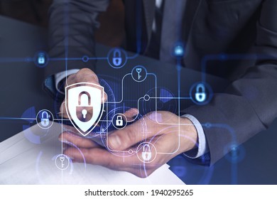 A programmer is browsing the Internet in smart phone to protect a cyber security from hacker attacks and save clients confidential data. Padlock Hologram icons over the typing hands. Formal wear. - Shutterstock ID 1940295265