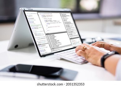 Programmer Or Coder At Office Desk Using Laptop