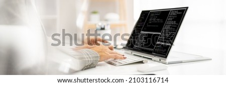 Programmer Or Coder At Office Desk Using Laptop